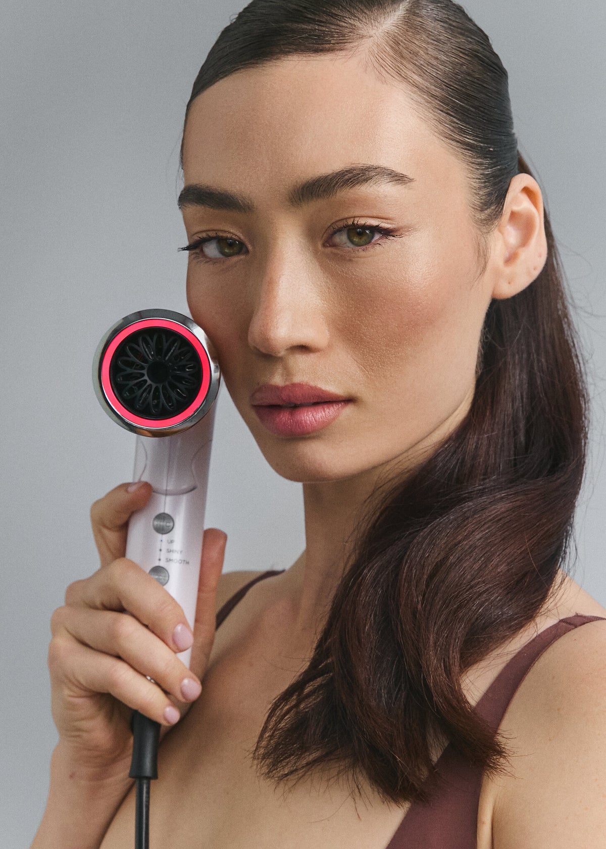 Model holding Lift Dryer Smart with the nozzle light on