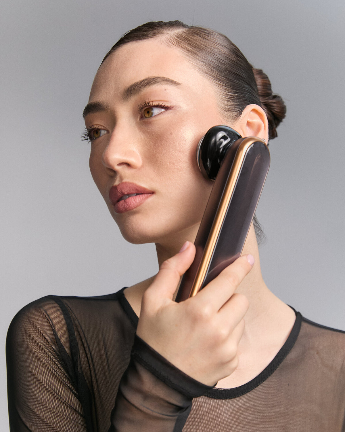 Model using Photo Plus Prestige SP III on her cheek, black mesh top