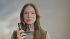 Woman gliding the Photo PLUS Prestige SP III along her cheek, its red LED glowing